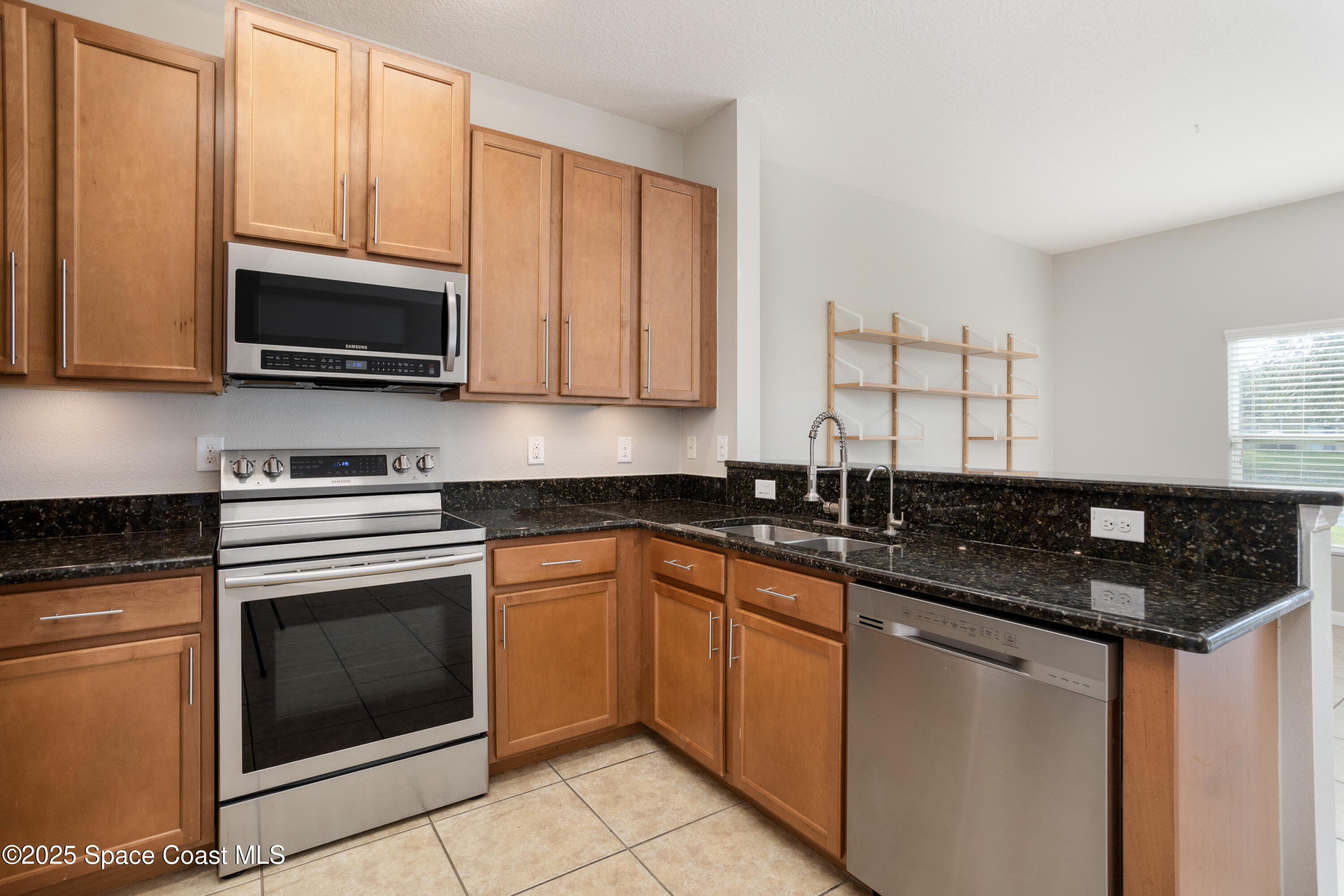 2780 Reston Street, Unit 104 Melbourne, FL 32935 - Photo 7 of 29 a kitchen with a sink stove and microwave