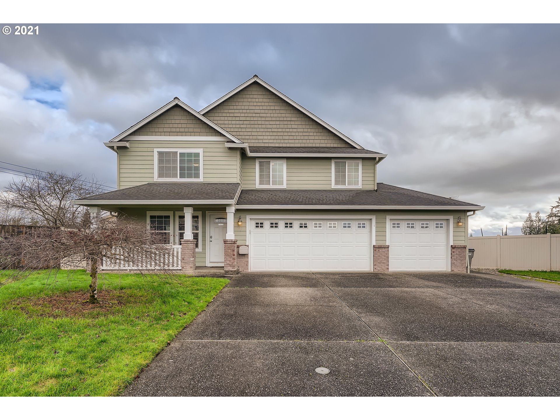 2417 North 9th Circle Ridgefield, WA 98642 - Photo 1 of 32 a front view of a house with a yard and garage