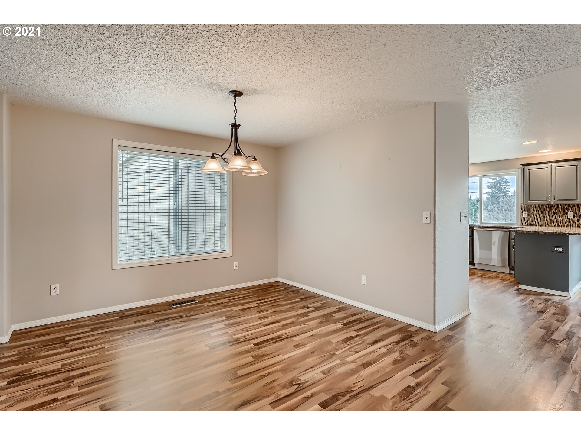 2417 North 9th Circle Ridgefield, WA 98642 - Photo 12 of 32 a view of an empty room with kitchen and a window