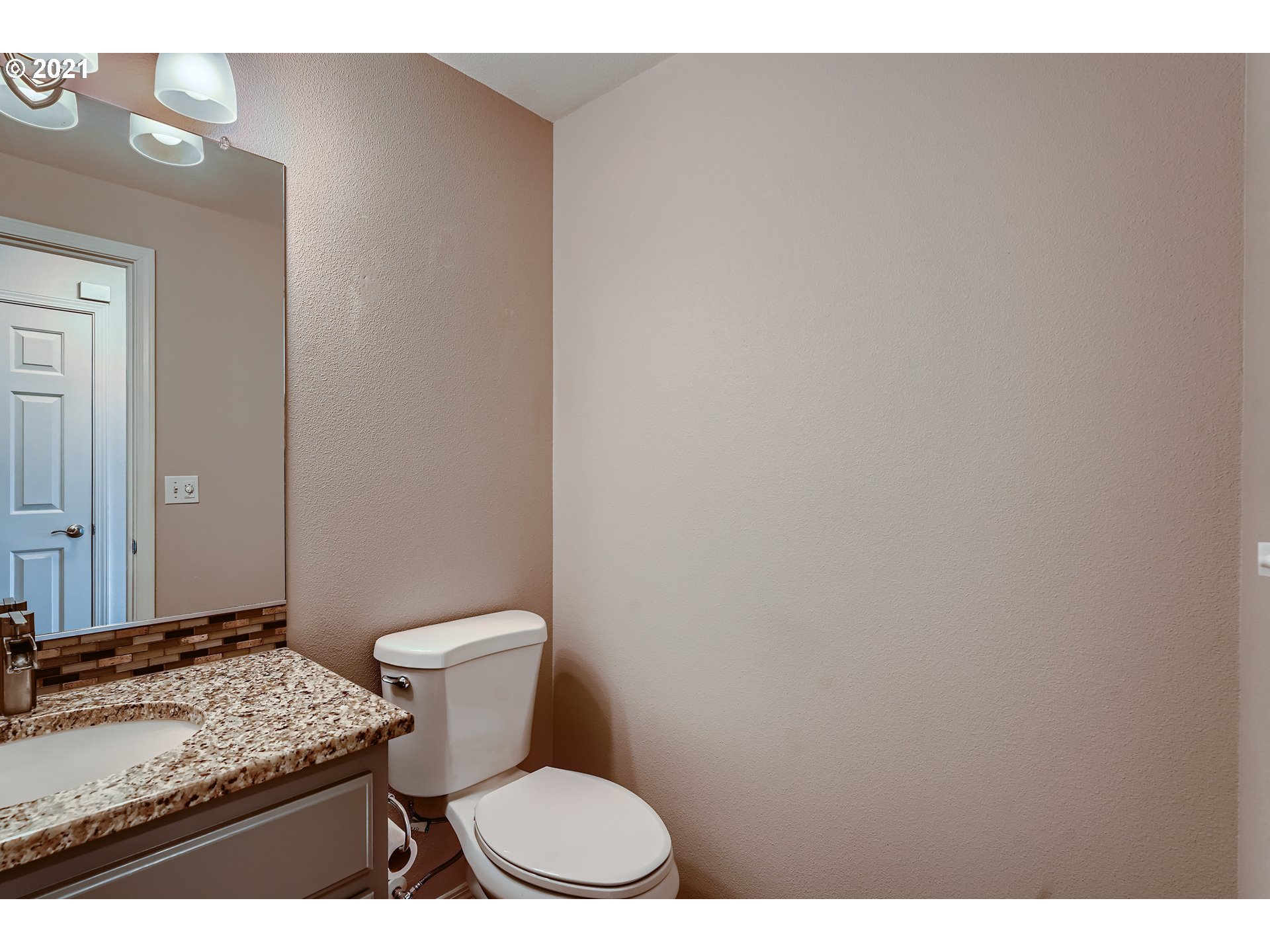 2417 North 9th Circle Ridgefield, WA 98642 - Photo 15 of 32 a bathroom with a granite countertop toilet and a sink