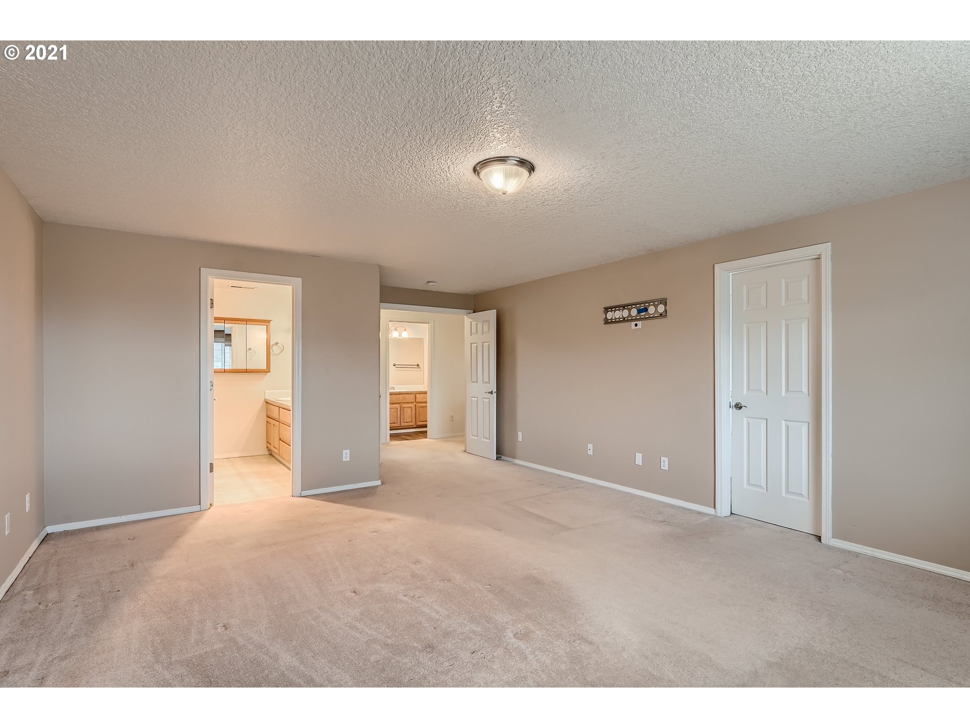 2417 North 9th Circle Ridgefield, WA 98642 - Photo 17 of 32 a view of an empty room with window and wooden floor