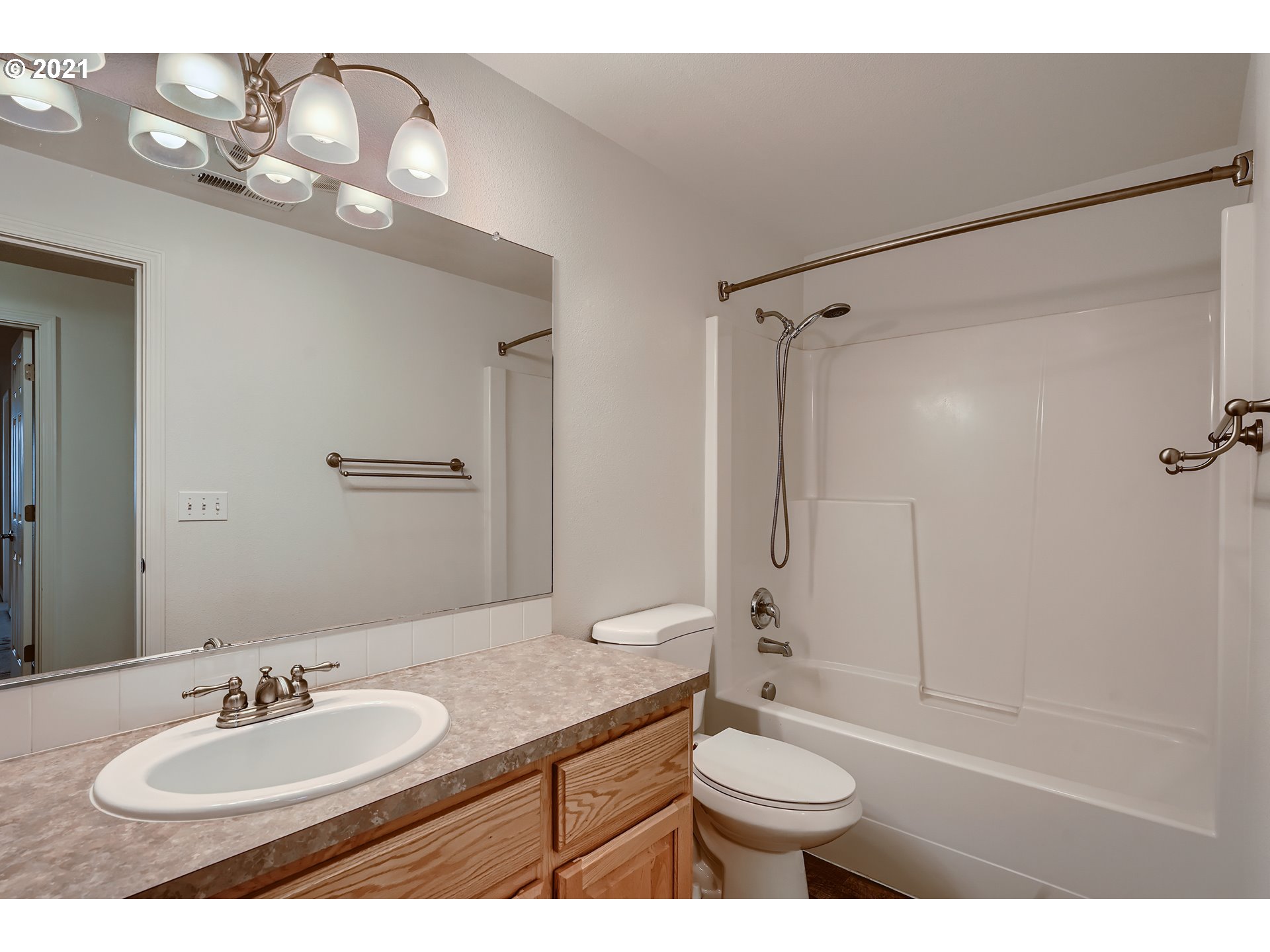 2417 North 9th Circle Ridgefield, WA 98642 - Photo 26 of 32 a bathroom with a sink a toilet and a mirror