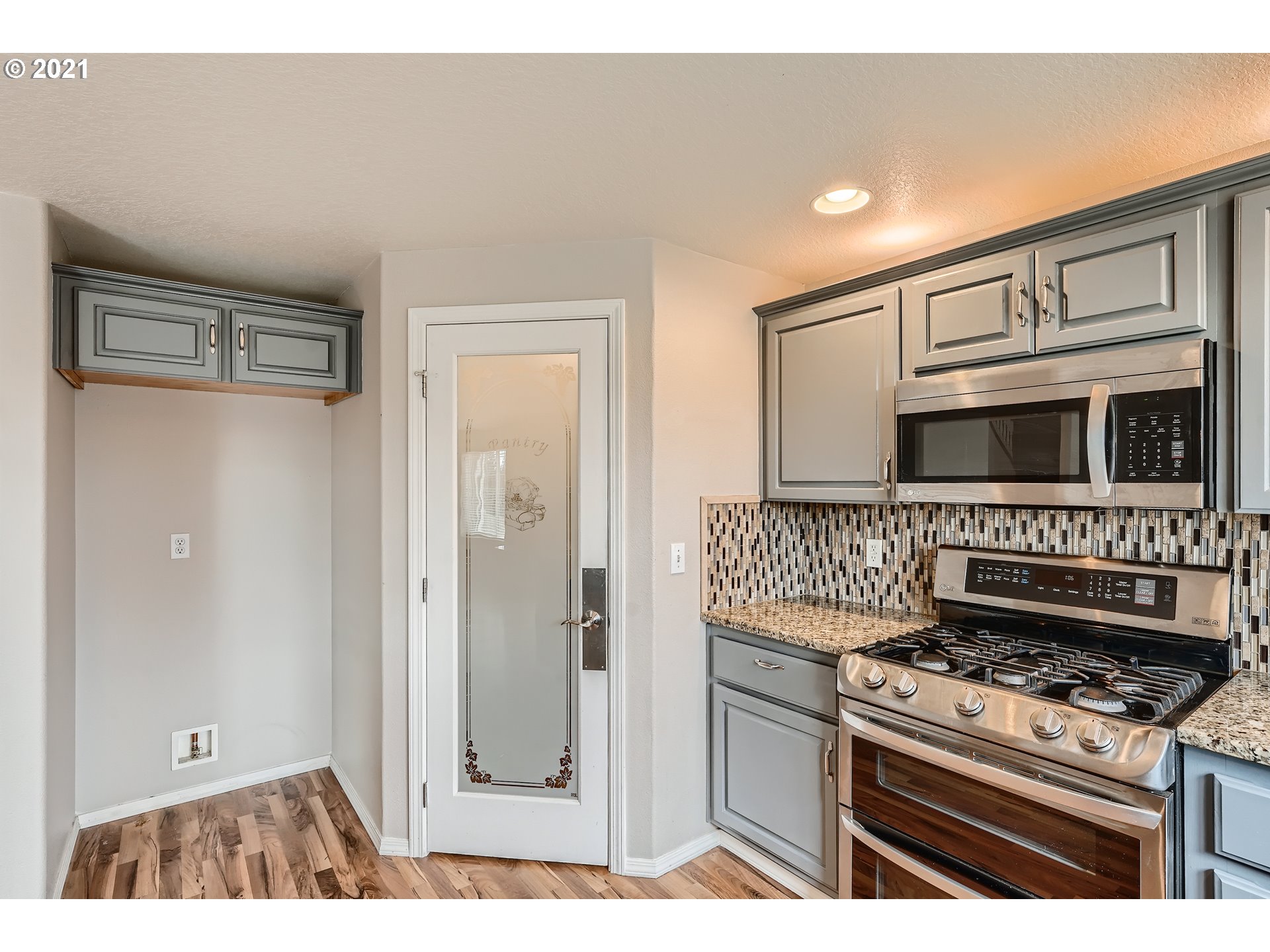 2417 North 9th Circle Ridgefield, WA 98642 - Photo 5 of 32 a kitchen view of a stove and a refrigerator