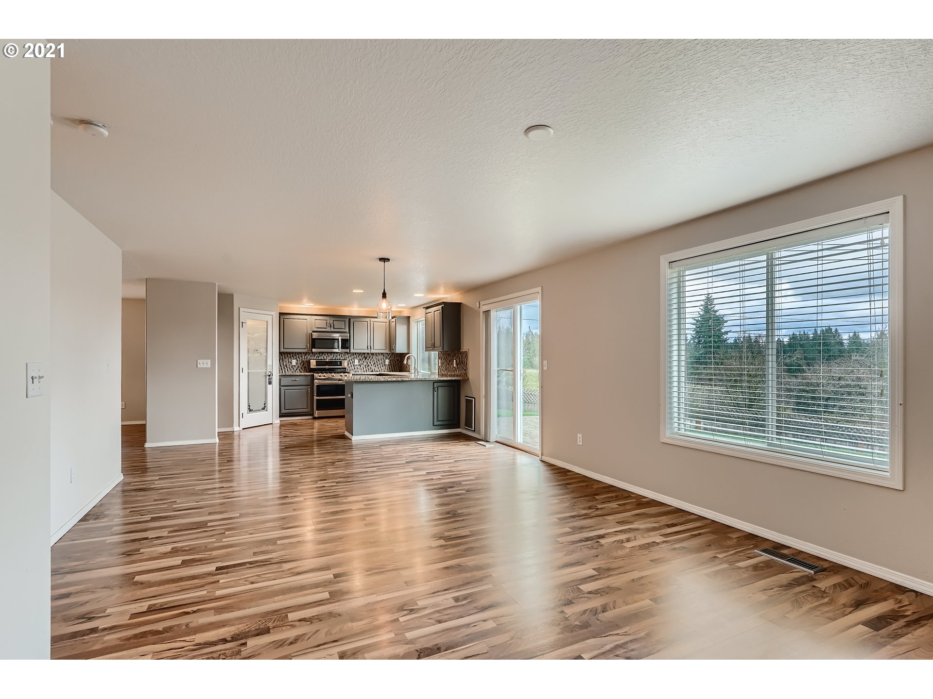 2417 North 9th Circle Ridgefield, WA 98642 - Photo 7 of 32 a view of kitchen and dining room with wooden floor