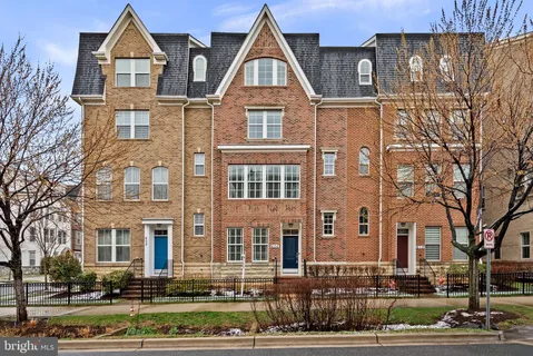 a front view of a residential apartment building with a yard