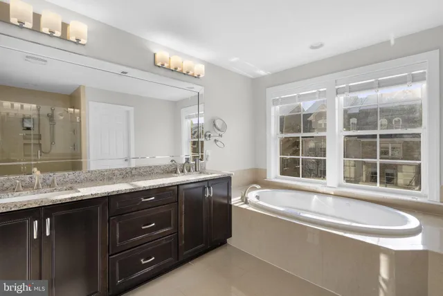a bathroom with a glass shower door and a mirror