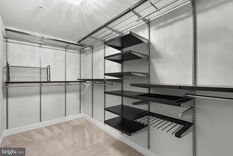 a bathroom with a glass shower door and a mirror