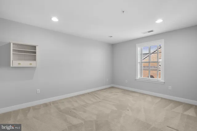 a bathroom with a granite countertop sink a toilet a mirror and shower