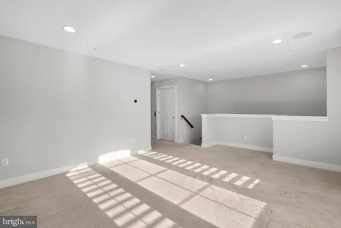 an empty room with closet and mirror