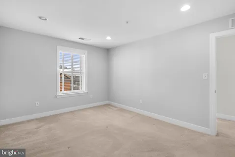 a bathroom with a granite countertop sink a toilet a mirror and shower