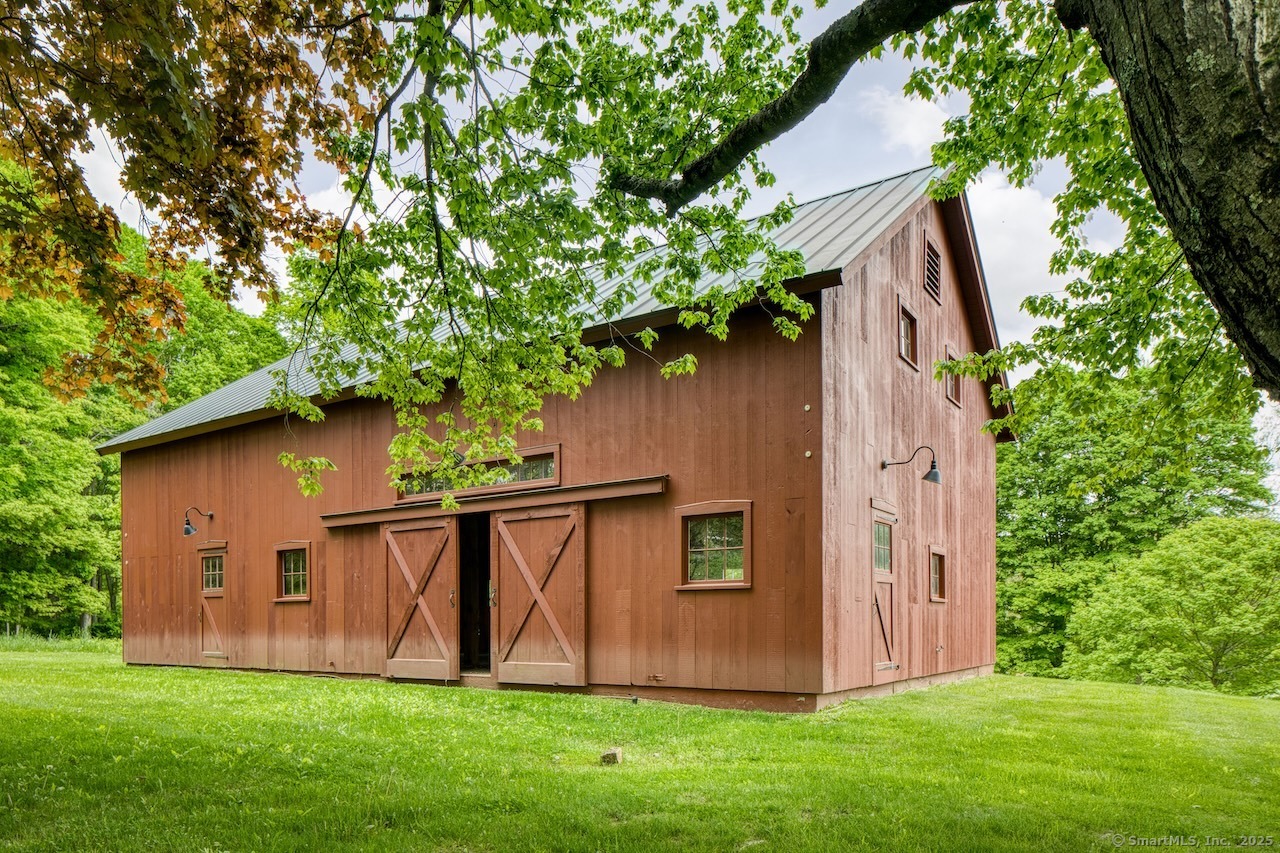 11 Valley Road Salisbury, CT 06039 - Photo 4 of 40 a view of backyard with potted plants and large tree