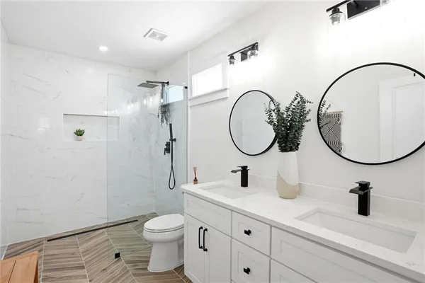 a bathroom with a toilet a sink and a mirror