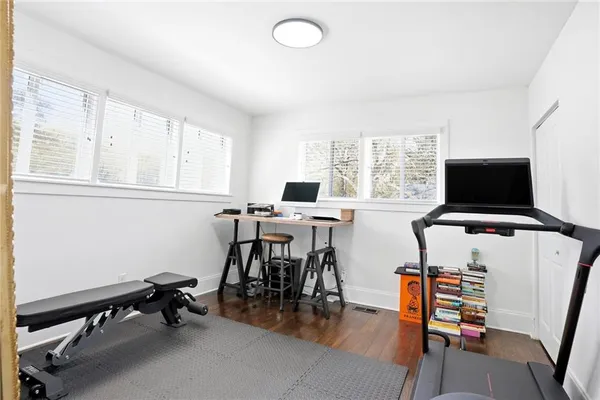 a view of a workspace with furniture and a flat screen tv