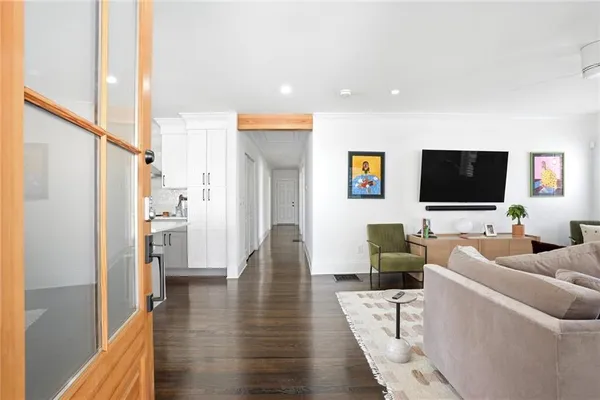 a living room with furniture wooden floor and a flat screen tv
