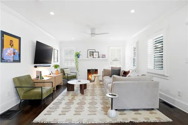 a living room with fireplace furniture and a flat screen tv