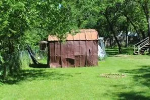 a view of a backyard with wooden fence