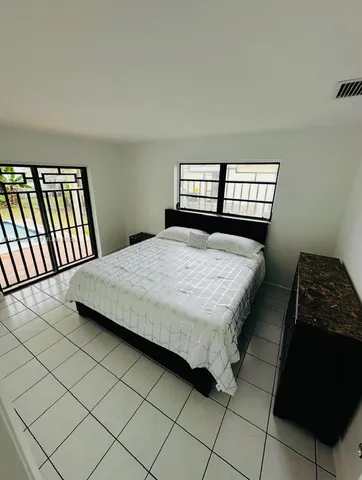 a kitchen with a sink a counter top space appliances and cabinets