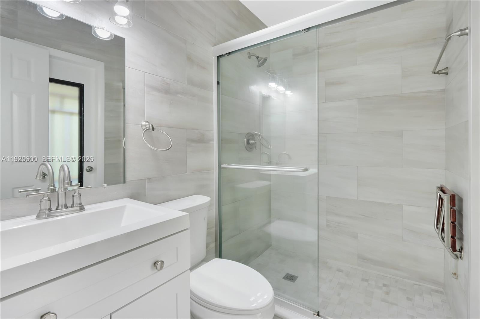 3225 Southwest 94th Avenue Miami, FL 33165 - Photo 2 of 12 a bathroom with a sink a toilet and shower