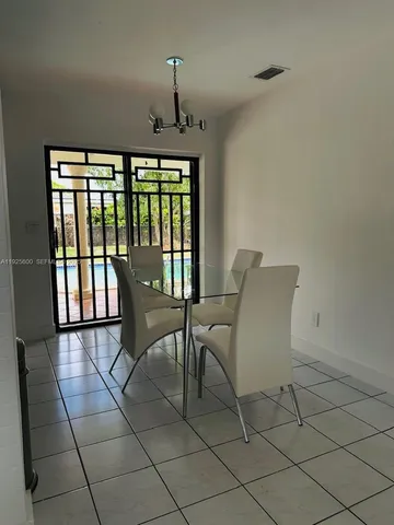 a view of a room with furniture and chandelier