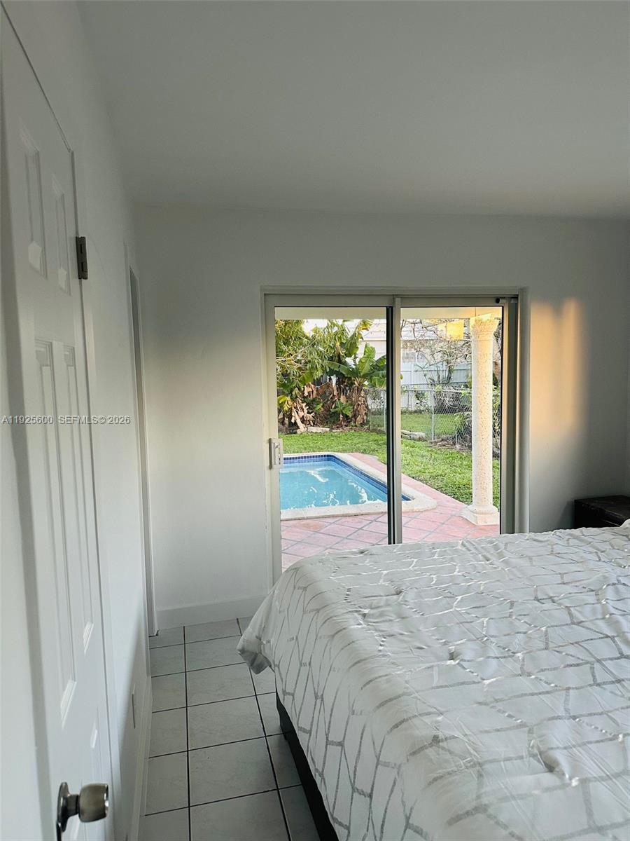 3225 Southwest 94th Avenue Miami, FL 33165 - Photo 8 of 12 a bed sitting in a bedroom next to a window