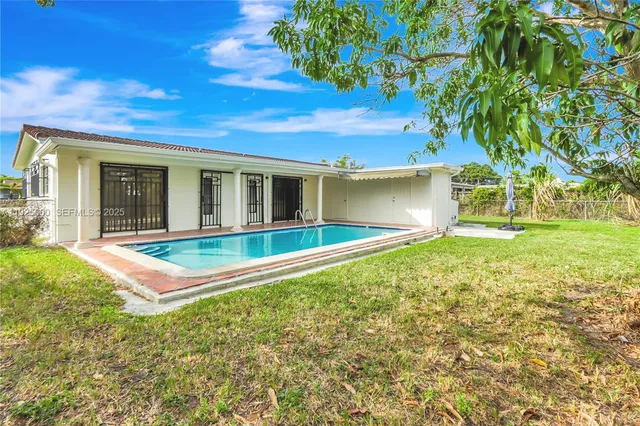 a front view of a house with a yard table and chairs