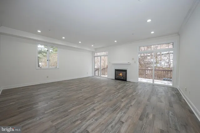 a view of a kitchen with a sink a window wooden floor and chandelier