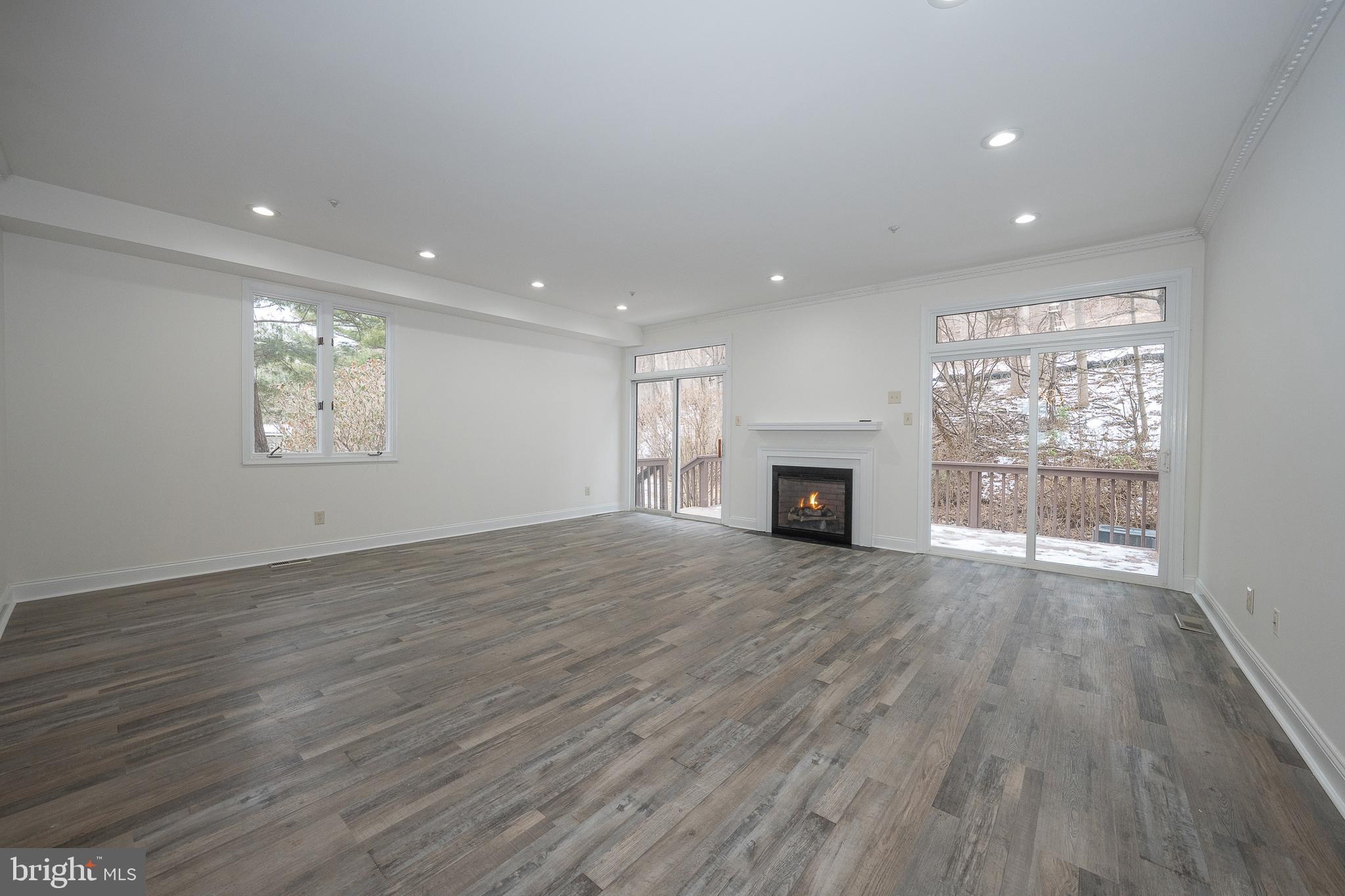 514 Waters Edge Newtown Square, PA 19073 - Photo 11 of 29 an empty room with wooden floor and fireplace