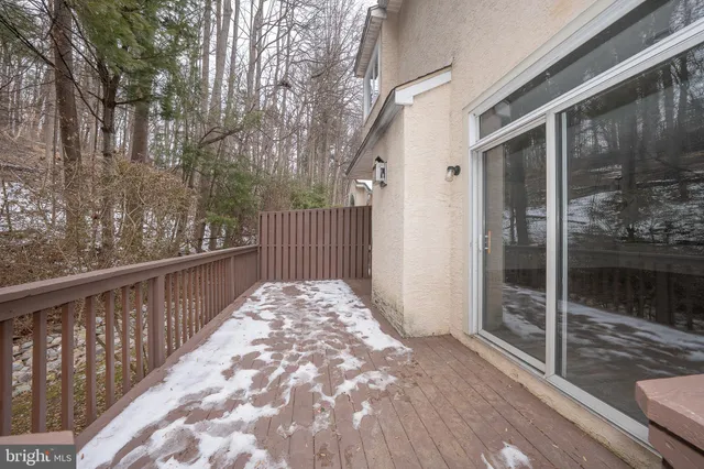 a view of an empty room with wooden floor fireplace and a window
