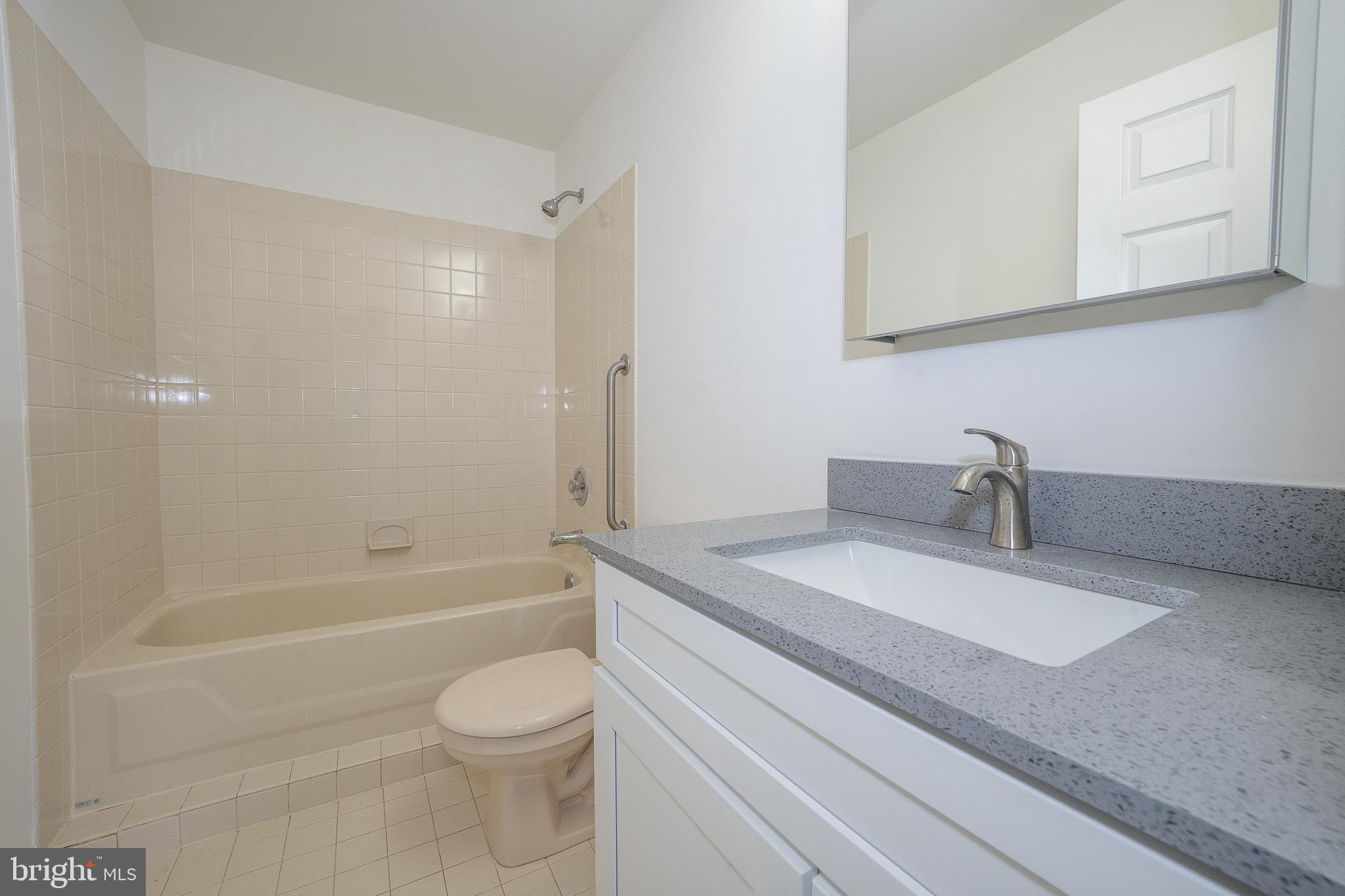 514 Waters Edge Newtown Square, PA 19073 - Photo 18 of 29 a bathroom with a granite countertop sink a toilet and bathtub
