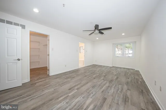 a bathroom with a granite countertop sink a toilet and bathtub