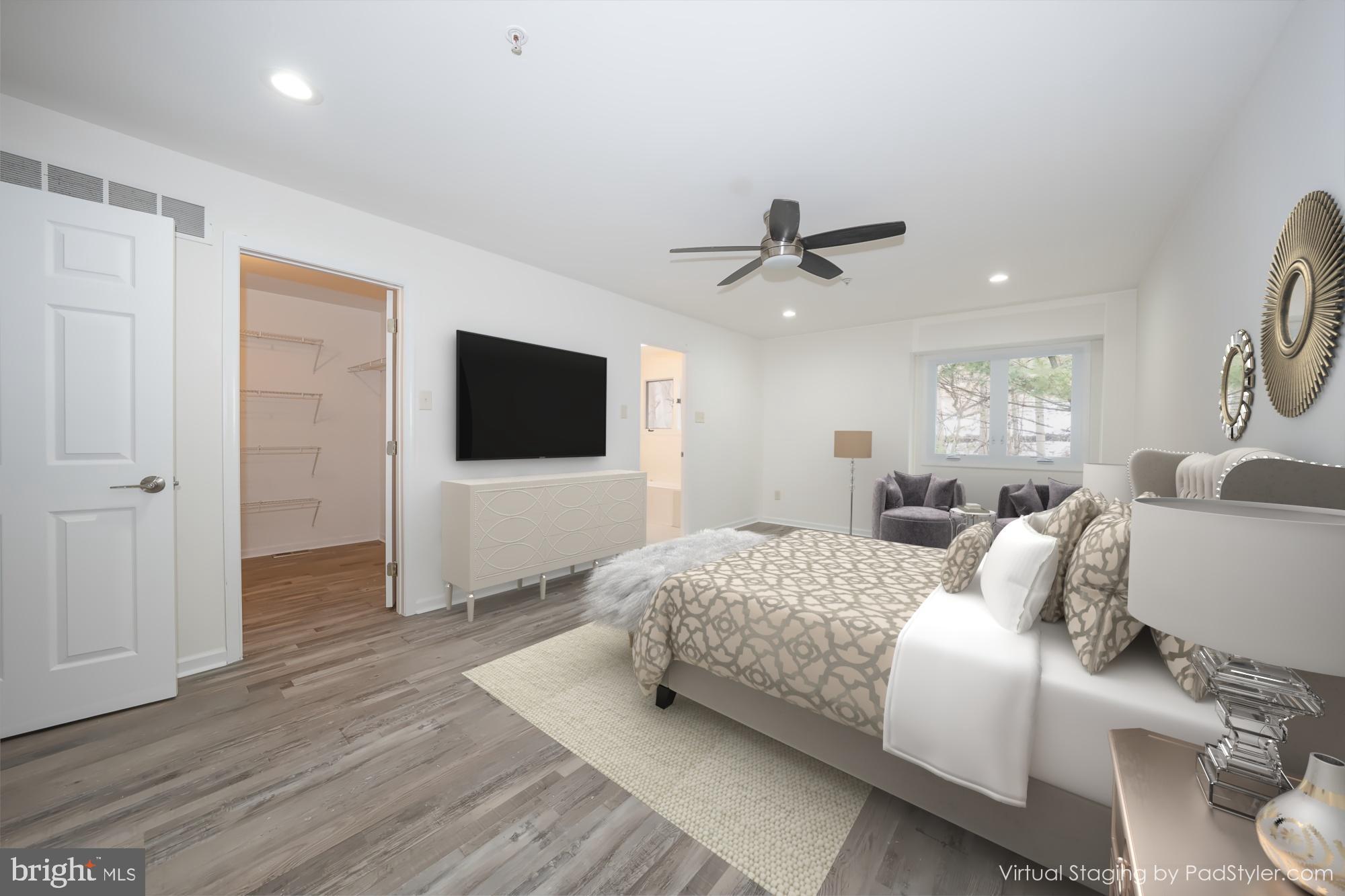 514 Waters Edge Newtown Square, PA 19073 - Photo 19 of 29 a bedroom with a bed a flat screen tv and a couch