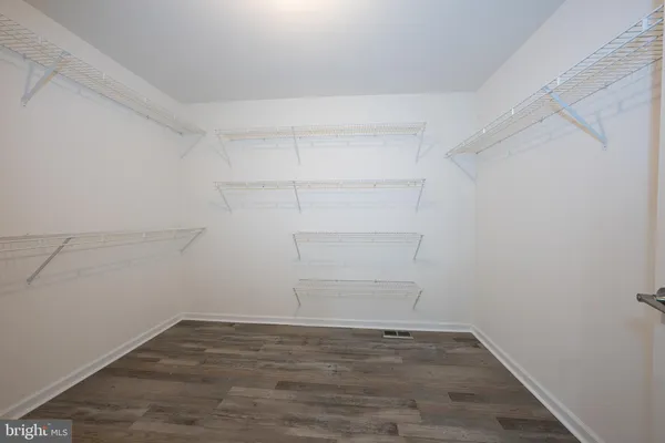 a bedroom with a bed a flat screen tv and a couch