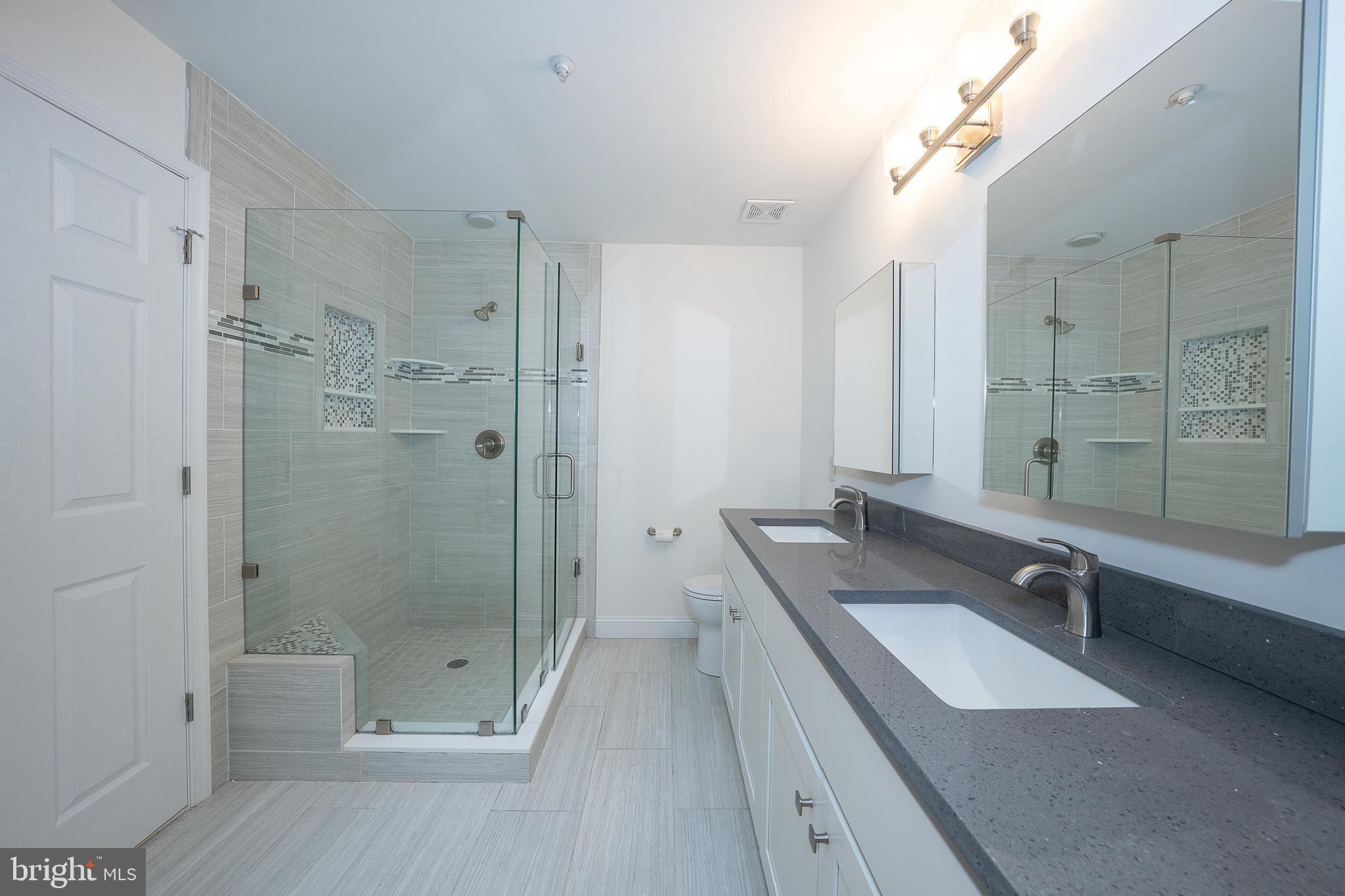 514 Waters Edge Newtown Square, PA 19073 - Photo 23 of 29 a bathroom with a granite countertop double vanity sink and shower