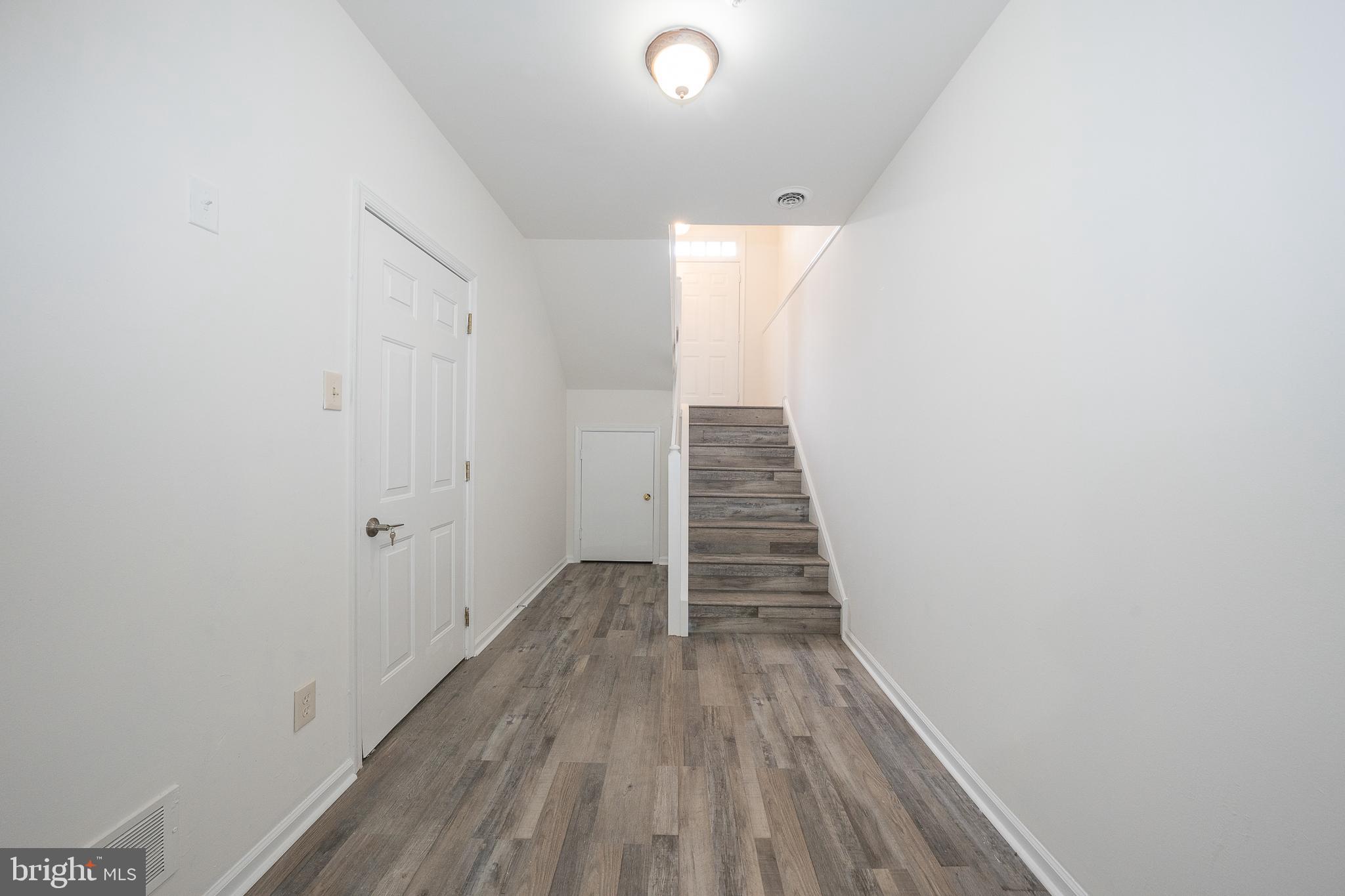 514 Waters Edge Newtown Square, PA 19073 - Photo 24 of 29 a view of a hallway with wooden floor and staircase