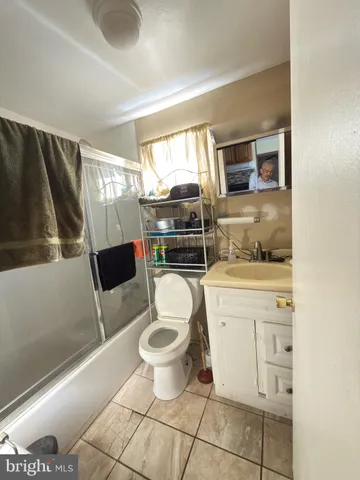 a spacious bathroom with a toilet sink and mirror