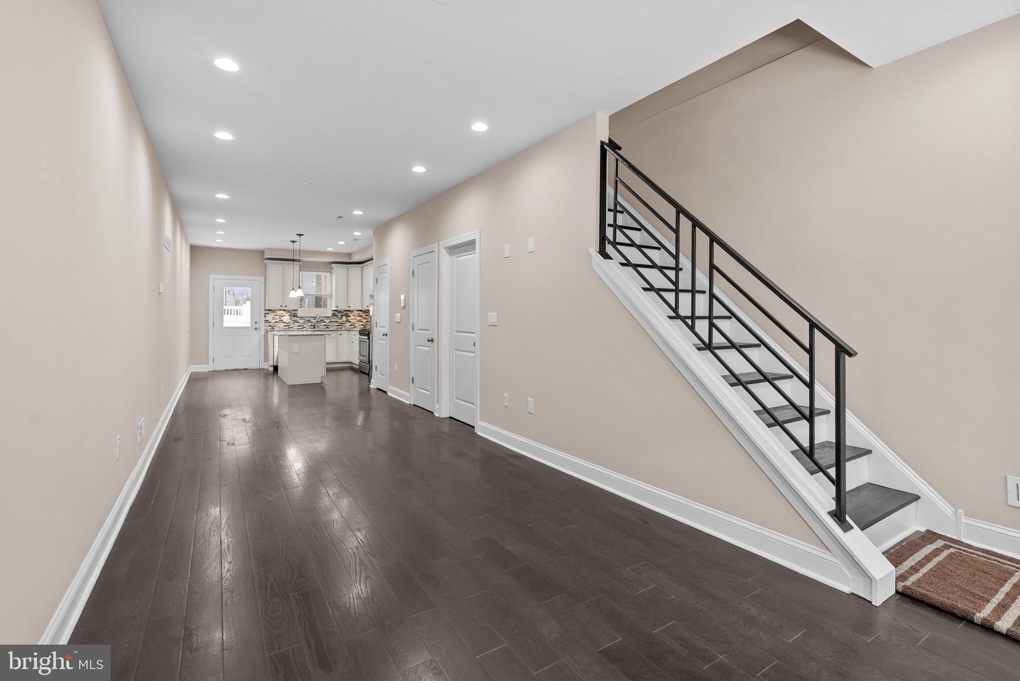 a view of entryway and hall with wooden floor