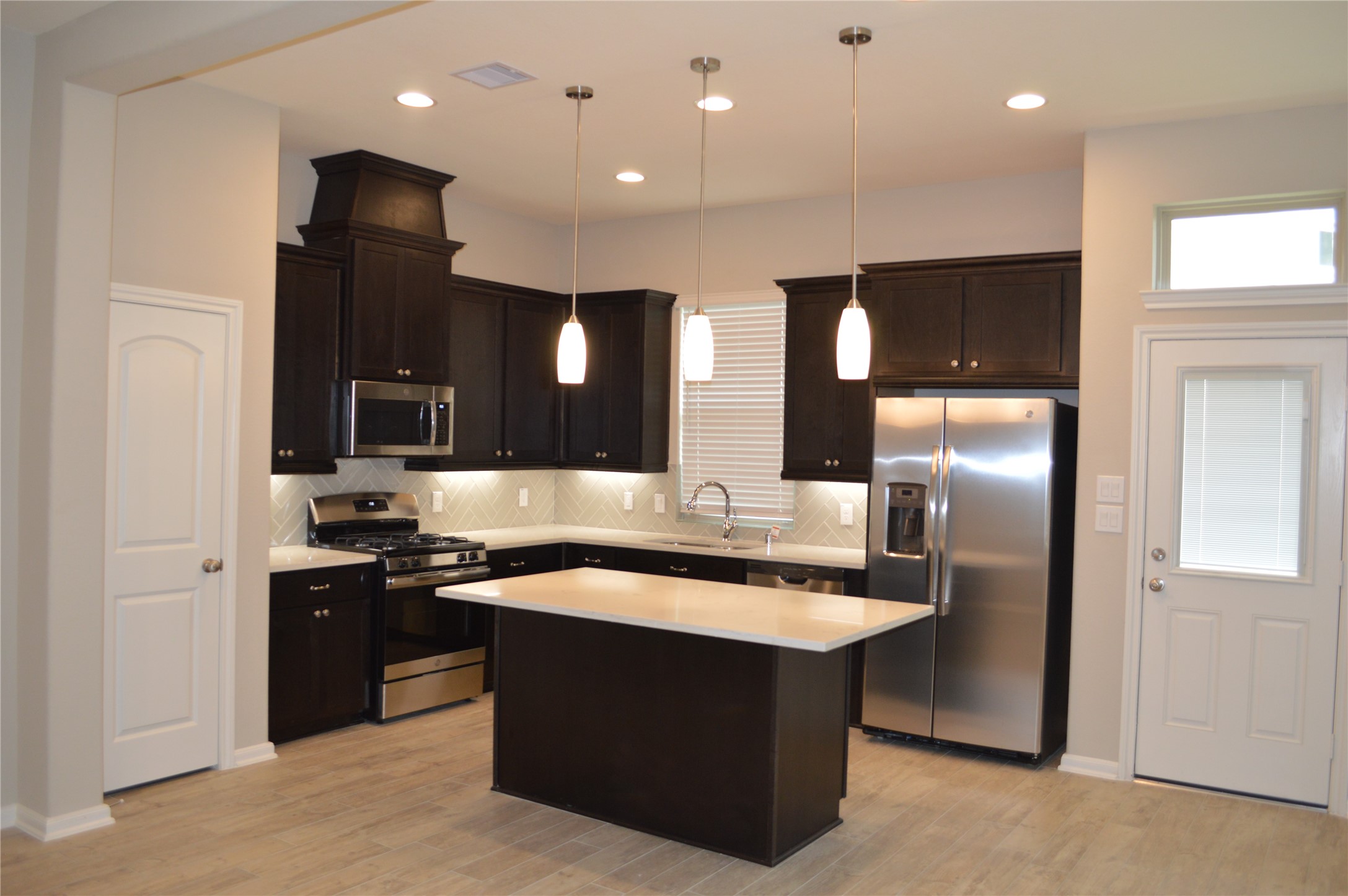 28043 Rocky Heights Drive Spring, TX 77386 - Photo 3 of 16 a large kitchen with a sink and stainless steel appliances