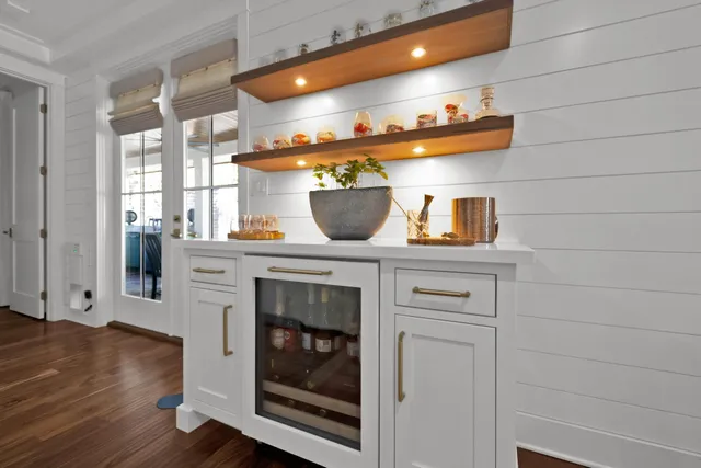 a kitchen with a stove and wooden floor