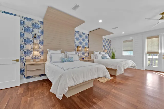 a large bedroom with furniture and wooden floor