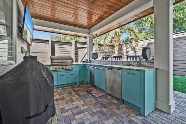 a view of backyard with seating space and wooden floor