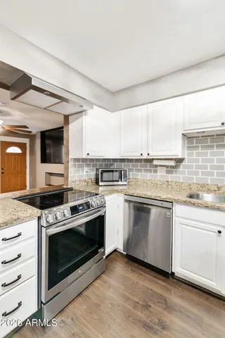 a kitchen with a stove oven and sink