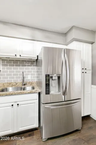 a kitchen with stainless steel appliances a refrigerator and a sink