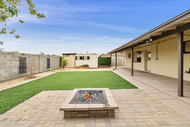 a view of a white house with a yard