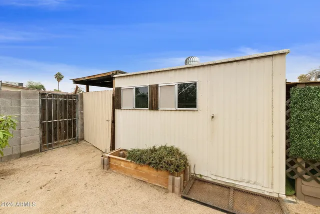 a view of a house with wooden fence
