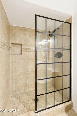 a bathroom with a sink mirror toilet and shower