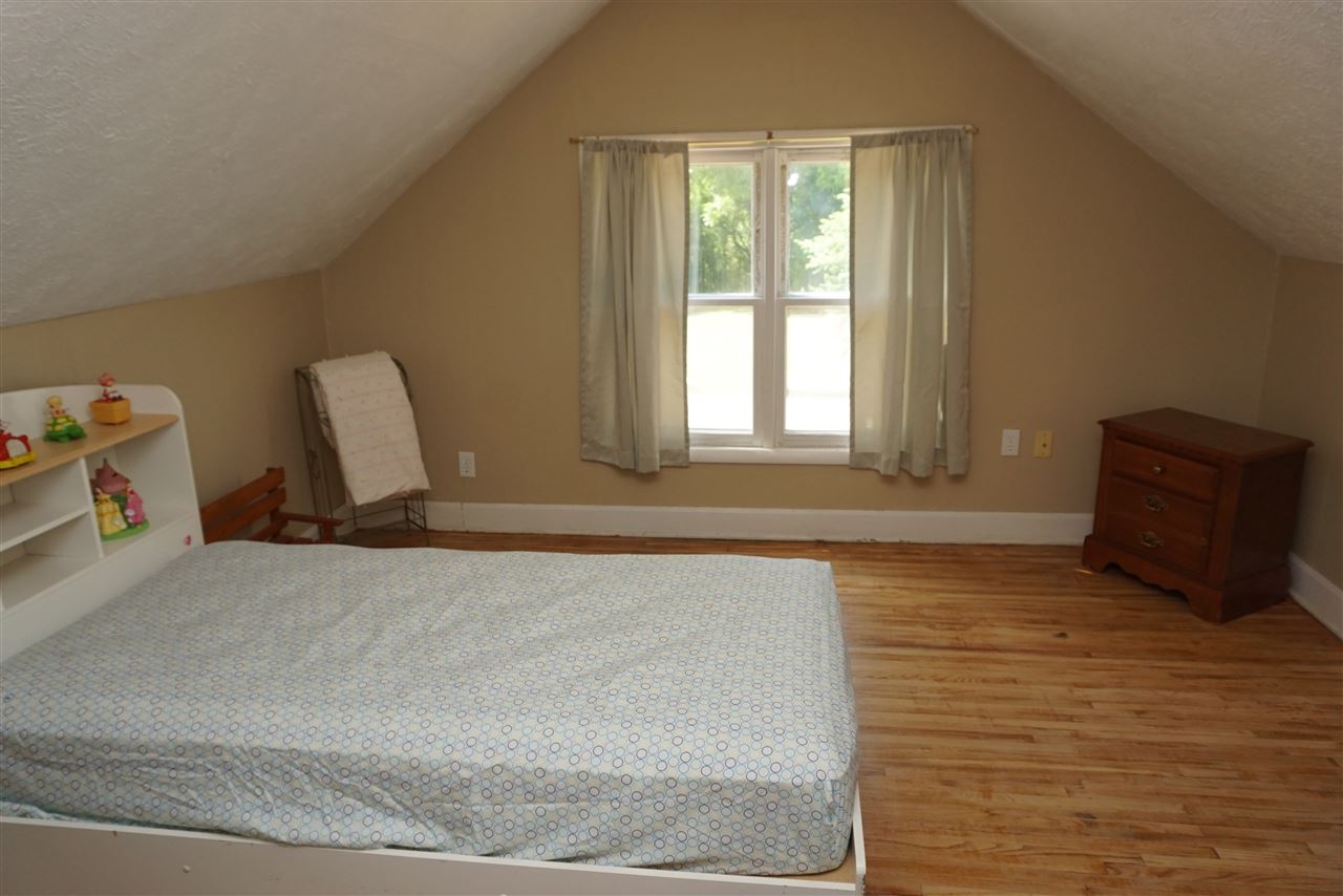4486 Safford Road Rockford, IL 61101 - Photo 11 of 19 a bedroom with a bed and wooden floor