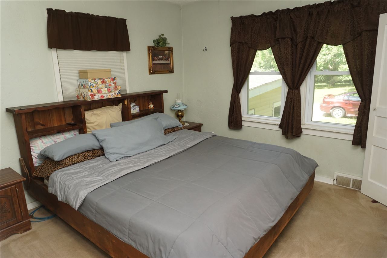4486 Safford Road Rockford, IL 61101 - Photo 5 of 19 a large bed sitting in a bedroom next to a window