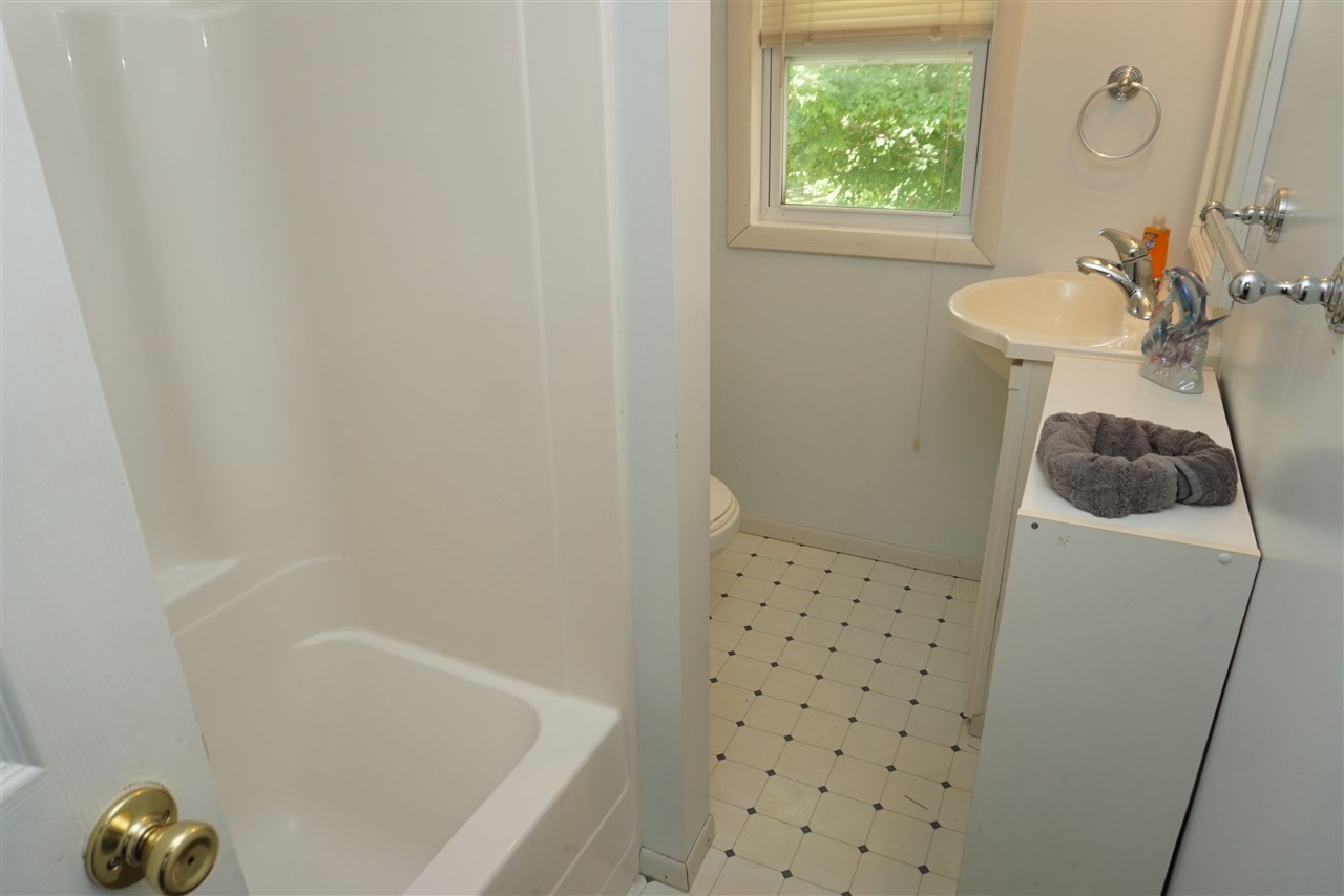 4486 Safford Road Rockford, IL 61101 - Photo 10 of 19 a bathroom with a sink and a shower curtain