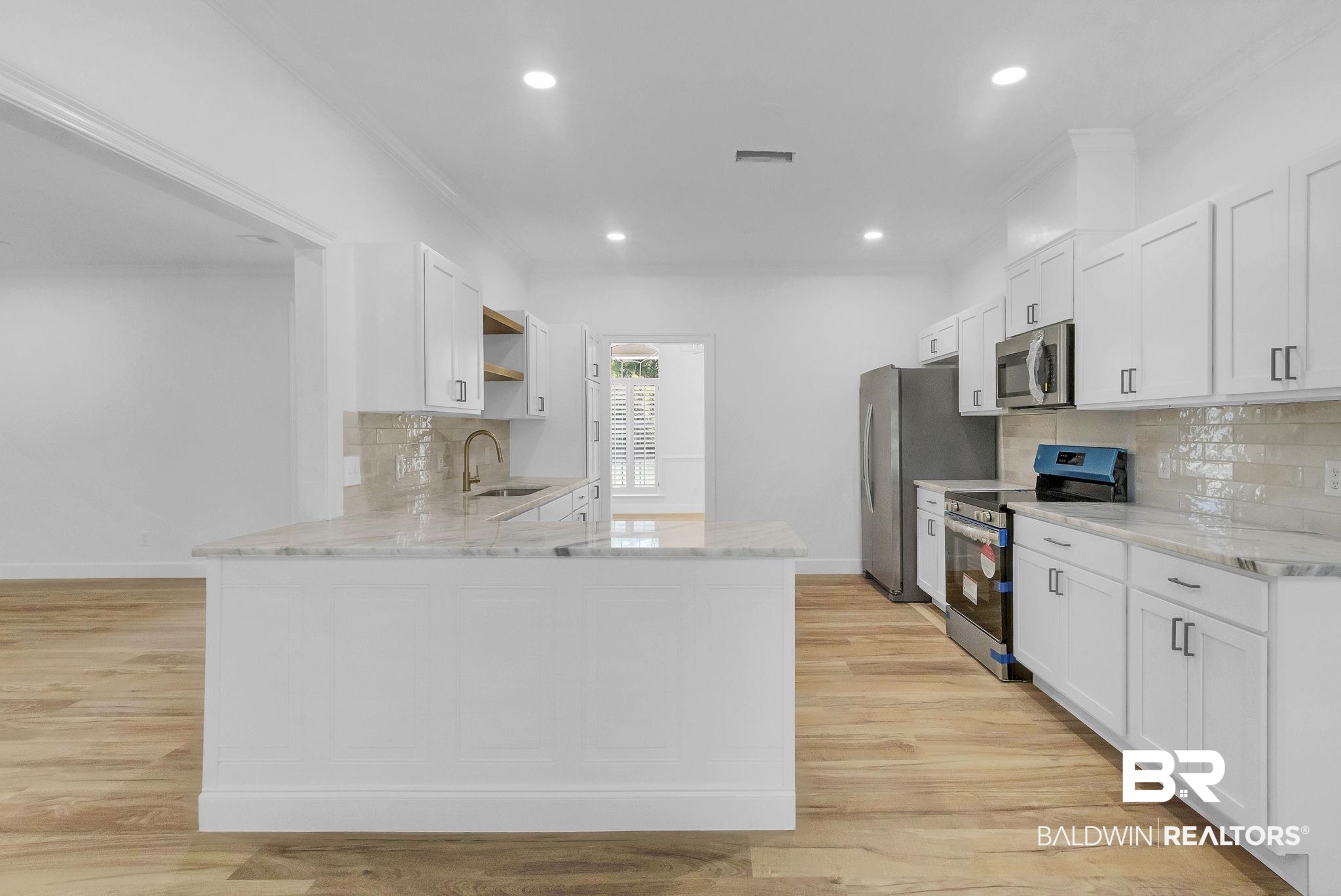 Kitchen featuring crown molding, open shelves, stainless steel appliances, a sink, and visible vents