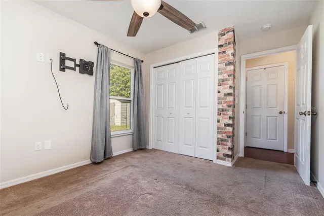 an empty room with windows and closet